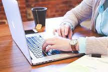 Homem com relógio no notebook